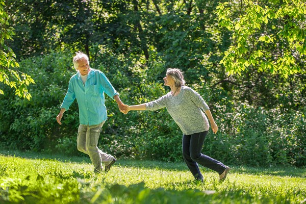 Central Park, New York City. Senior couple running in park.