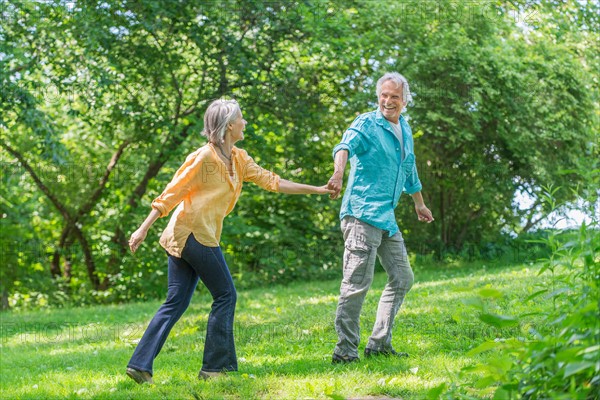 Central Park, New York City. Senior couple running in park.