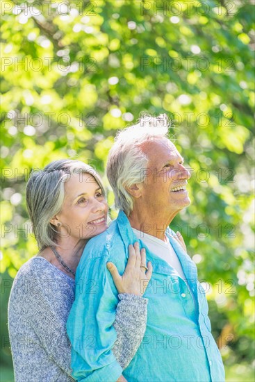 Central Park, New York City. Senior couple embracing in park.