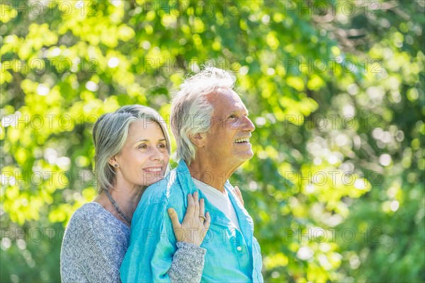 Central Park, New York City. Senior couple embracing in park.