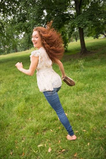 Young woman running in park.