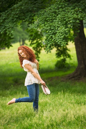 Young woman walking in park.