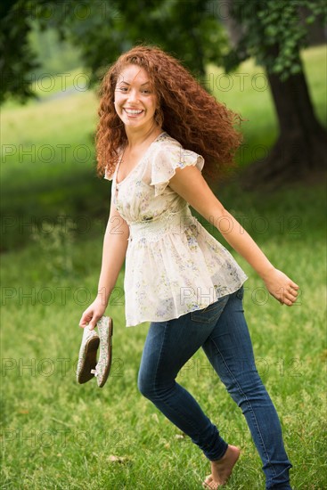 Young woman running in park.