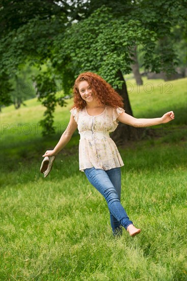 Young woman walking in park.