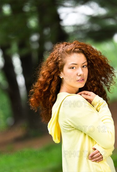 Portrait of young woman in park.