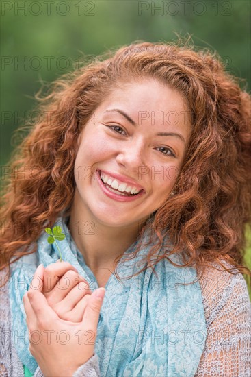 Portrait of young woman in park.