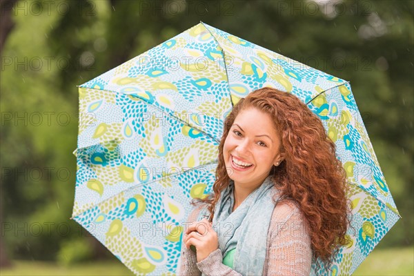 Portrait of young woman in park.