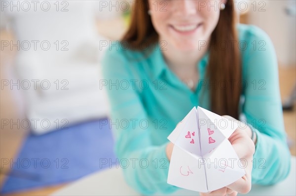 Teenage girl (14-15) showing origami