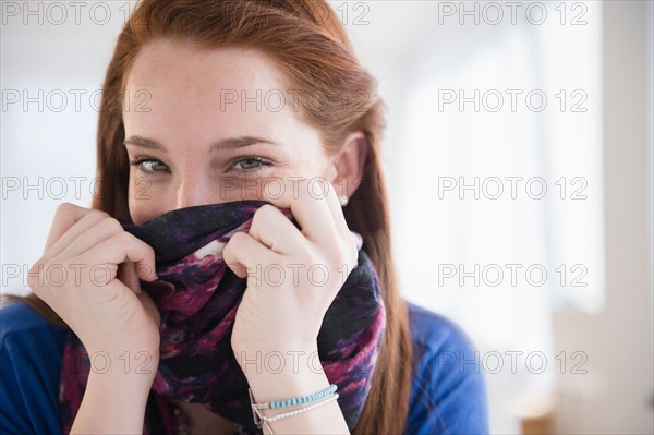 Portrait of teenage girl (14-15) covering face