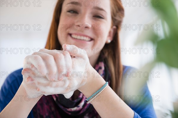 Teenage girl (14-15) washing hands