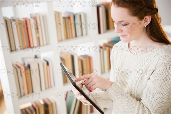 Teenage girl (14-15) using digital tablet