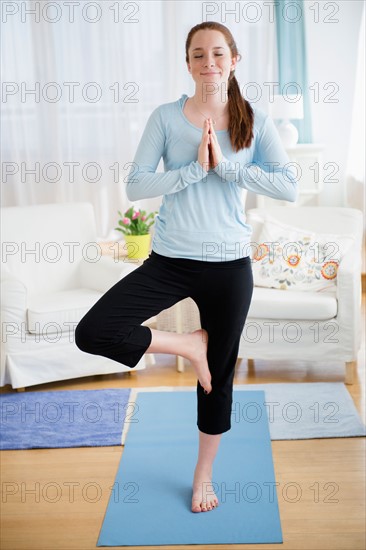 Teenage girl (14-15) practicing yoga