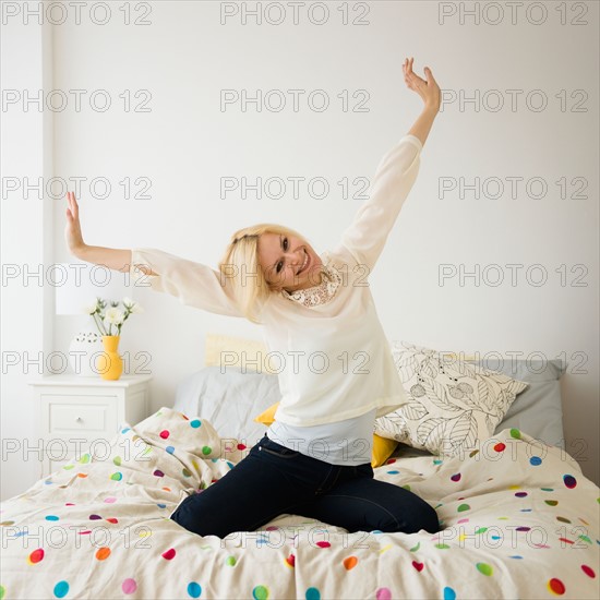 Young woman stretching in bed