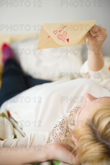 Young woman holding love letter