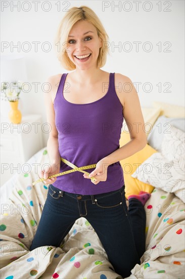 Young woman with measuring tape