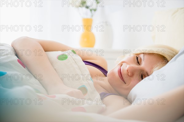 Young woman sleeping in bed