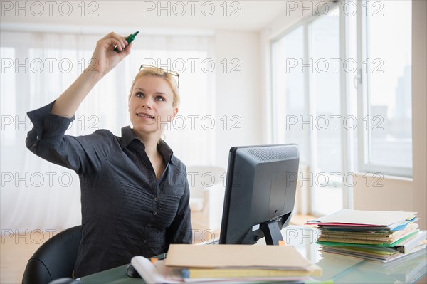 Young woman working at desk in office