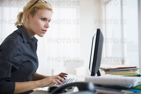 Young woman working at desk in office