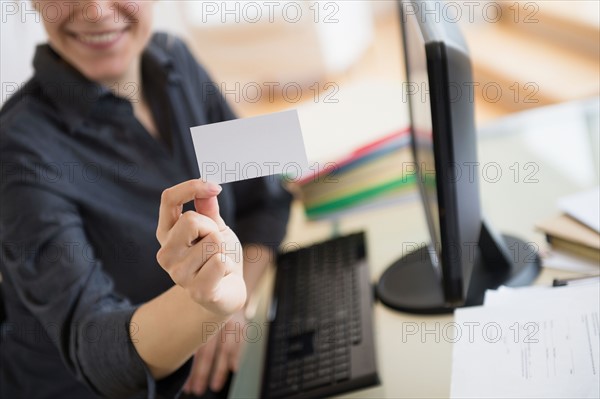 Young woman showing blank business card