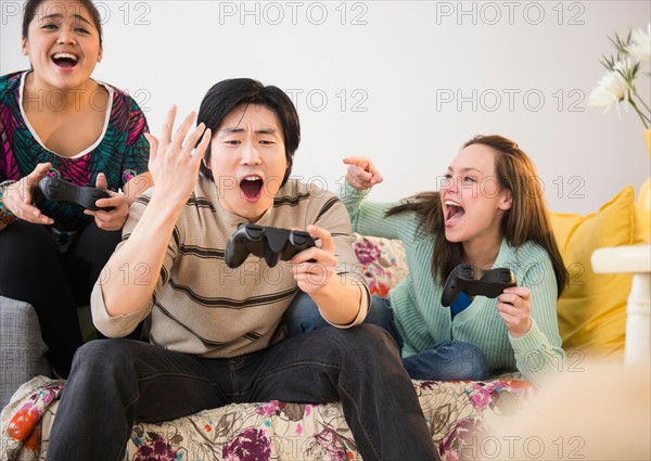 Young women and man playing video game