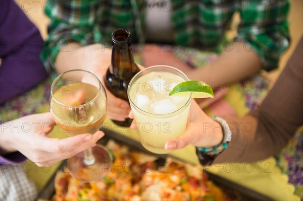 Young women and man toasting