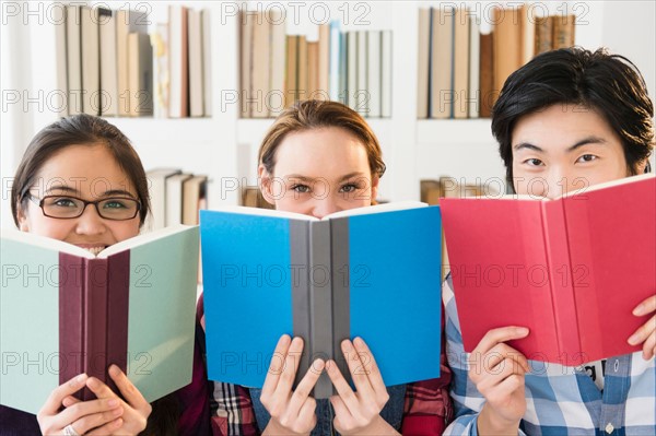 Young women and man studding in library