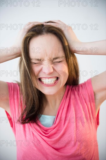 Studio shot of young woman in distress