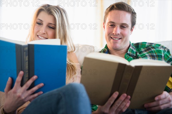 Couple on sofa reading