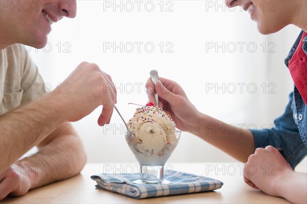 Couple eating one bowl of ice-cream