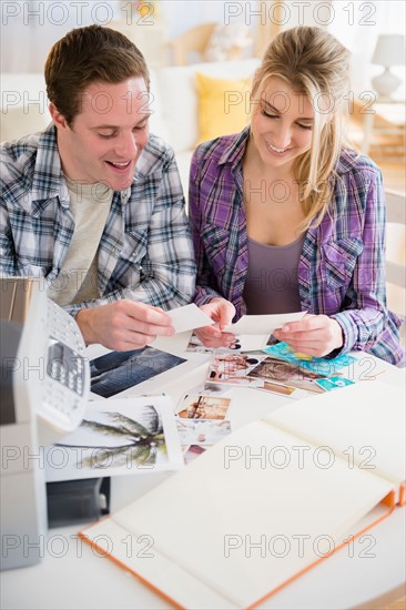 Couple preparing photo album