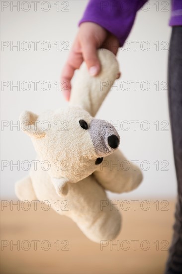 Girl (8-9) holding teddy bear