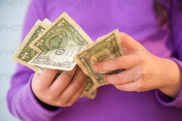 Girl (8-9) counting money