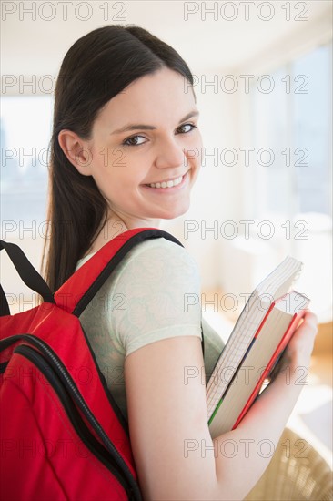 College student with books and backpack