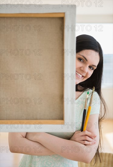 Art college student in front of canvas