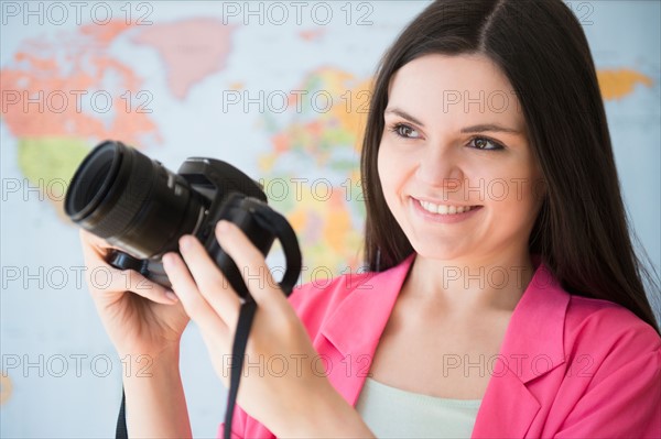 Young woman using dslr camera