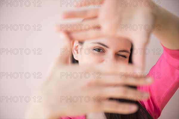 Young woman measuring length with hands