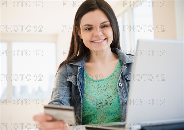 Young woman using laptop for online shopping