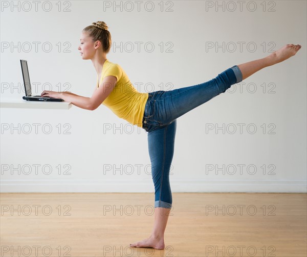 Portrait of teenage (16-17) ballerina using laptop