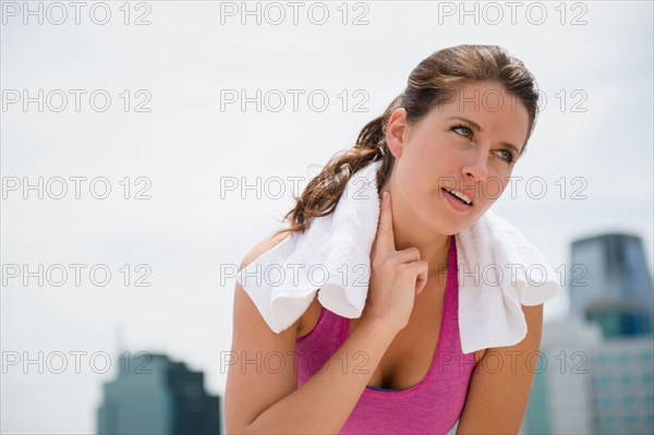 Portrait of young woman checking her pulse