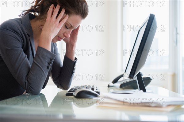 Portrait of overtired woman in office