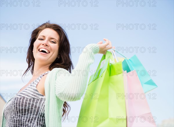 Happy woman holding shopping bags