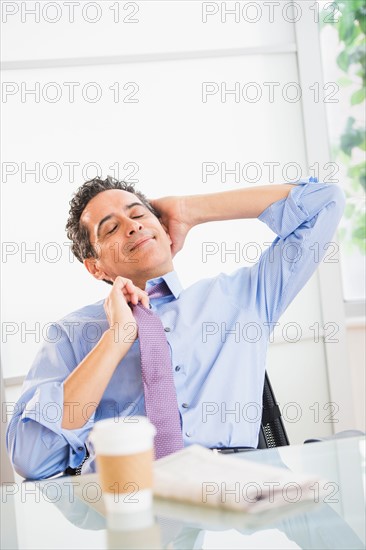 View of mature man relaxing in office