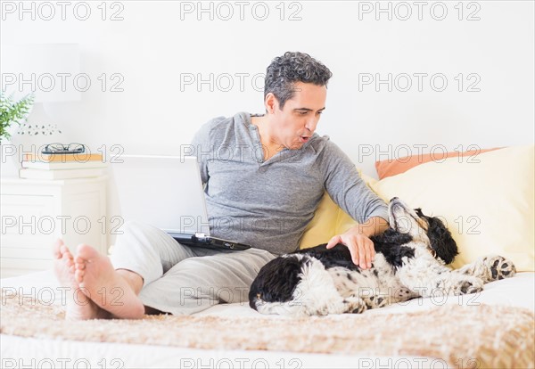 View of mature man using laptop at home