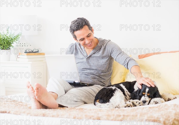 View of mature man using laptop at home