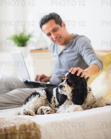 View of mature man petting dog