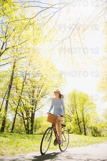 Mid adult woman riding bicycle