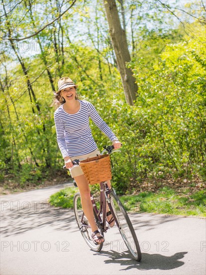 Mid adult woman riding bicycle