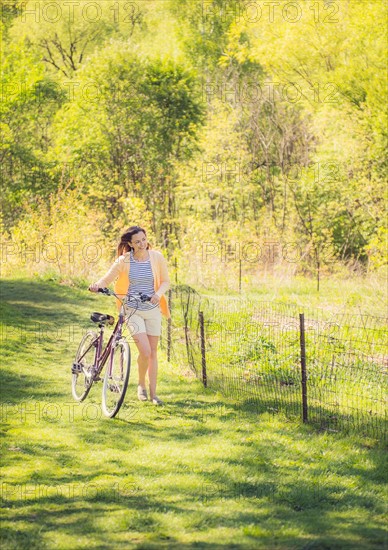 Mid adult woman with bicycle