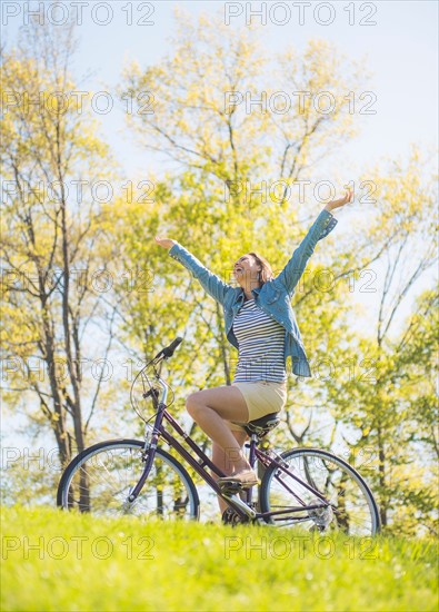 Mid adult woman riding bicycle