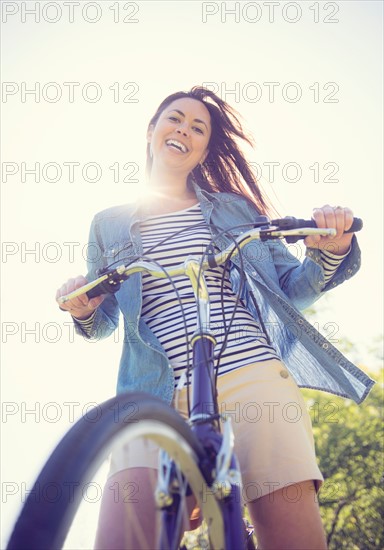 Portrait of mid adult woman with bicycle
